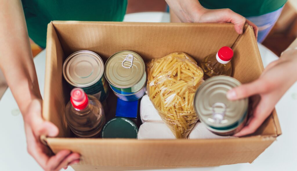 volunteer with box of food for donations