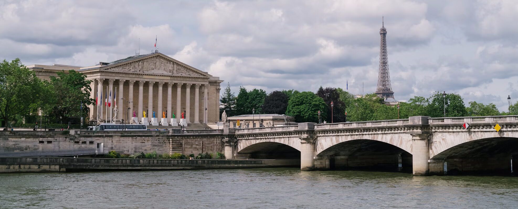 a bridge in paris with the eiffel tower in the distance